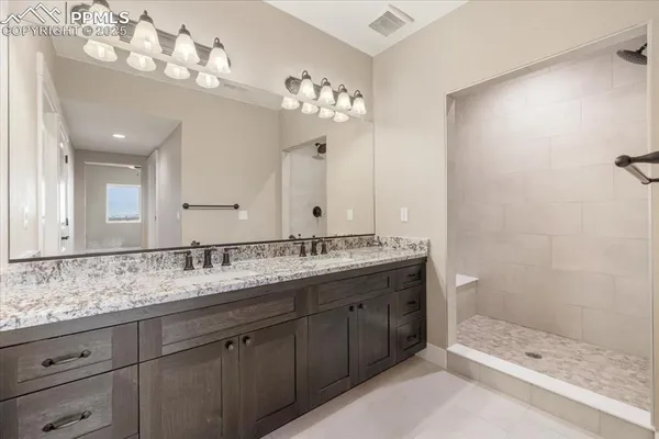 a bathroom with a sink double vanity and a shower