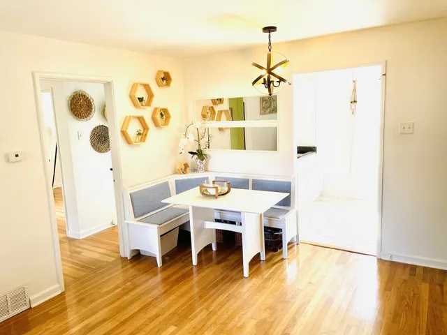 a dining room with furniture and wooden floor