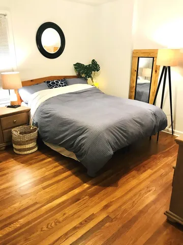 a bedroom with a bed and a large window