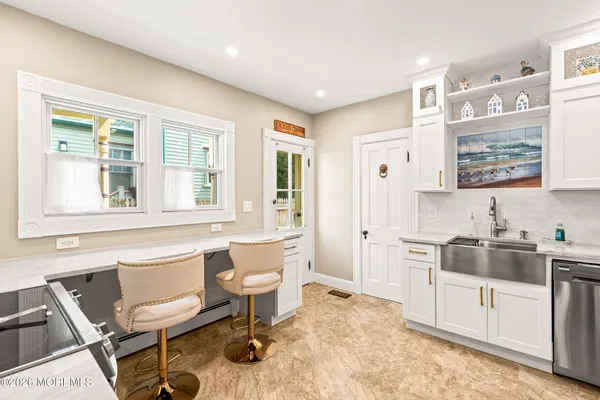a kitchen with stainless steel appliances granite countertop a stove and a white refrigerator