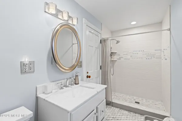 a kitchen with stainless steel appliances granite countertop a stove a sink a microwave a dining table and chairs with wooden floor