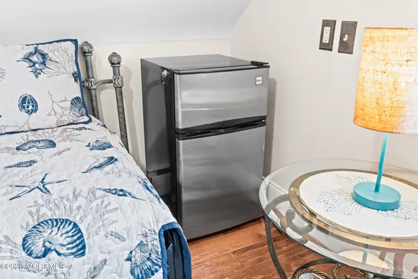 a view of a white house with large windows and a small yard