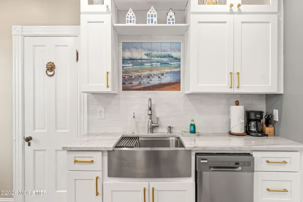 a bedroom with a bed a dresser and wooden floor