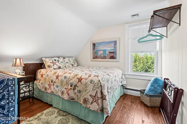 a bedroom with furniture and a wooden floor