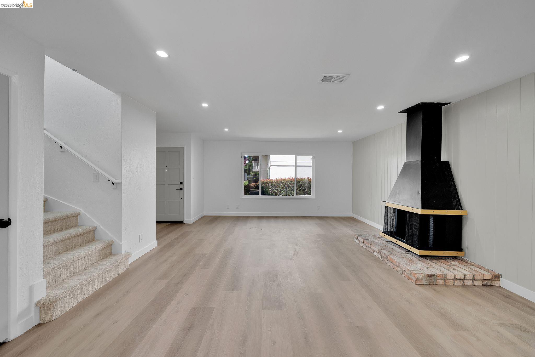 1808 Wildbrook Court, Unit D Concord, CA 94521 - Photo 8 of 47 a view of empty room with wooden floor and fan