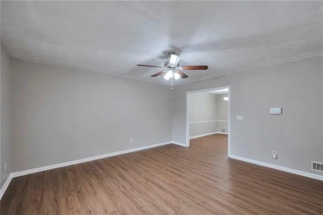 a view of an empty room with wooden floor