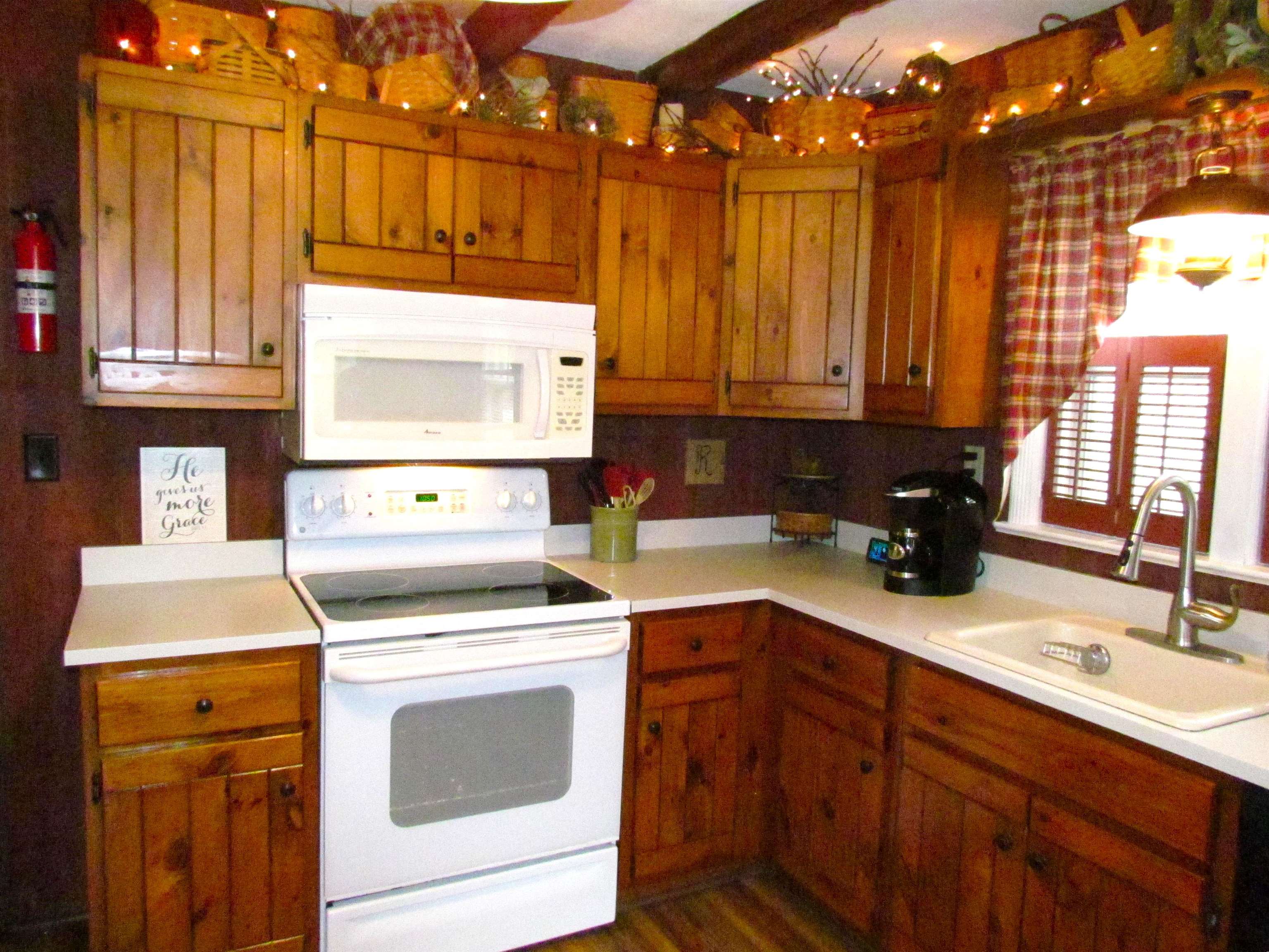 727 Elgin Street Cherry Valley, IL 61016 - Photo 12 of 35 a kitchen with a sink stove and cabinets