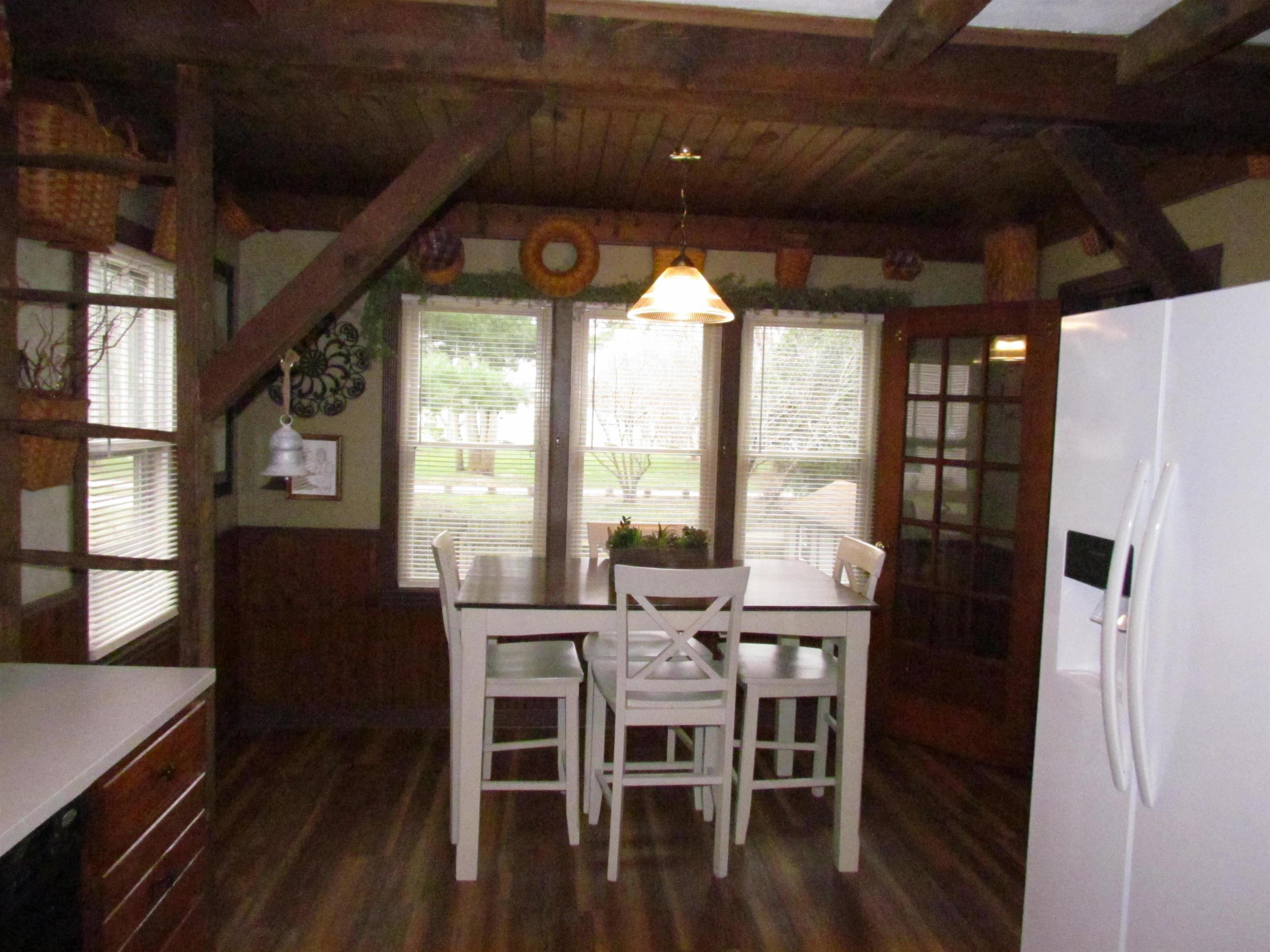 727 Elgin Street Cherry Valley, IL 61016 - Photo 13 of 35 a view of a dining room with furniture window and wooden floor