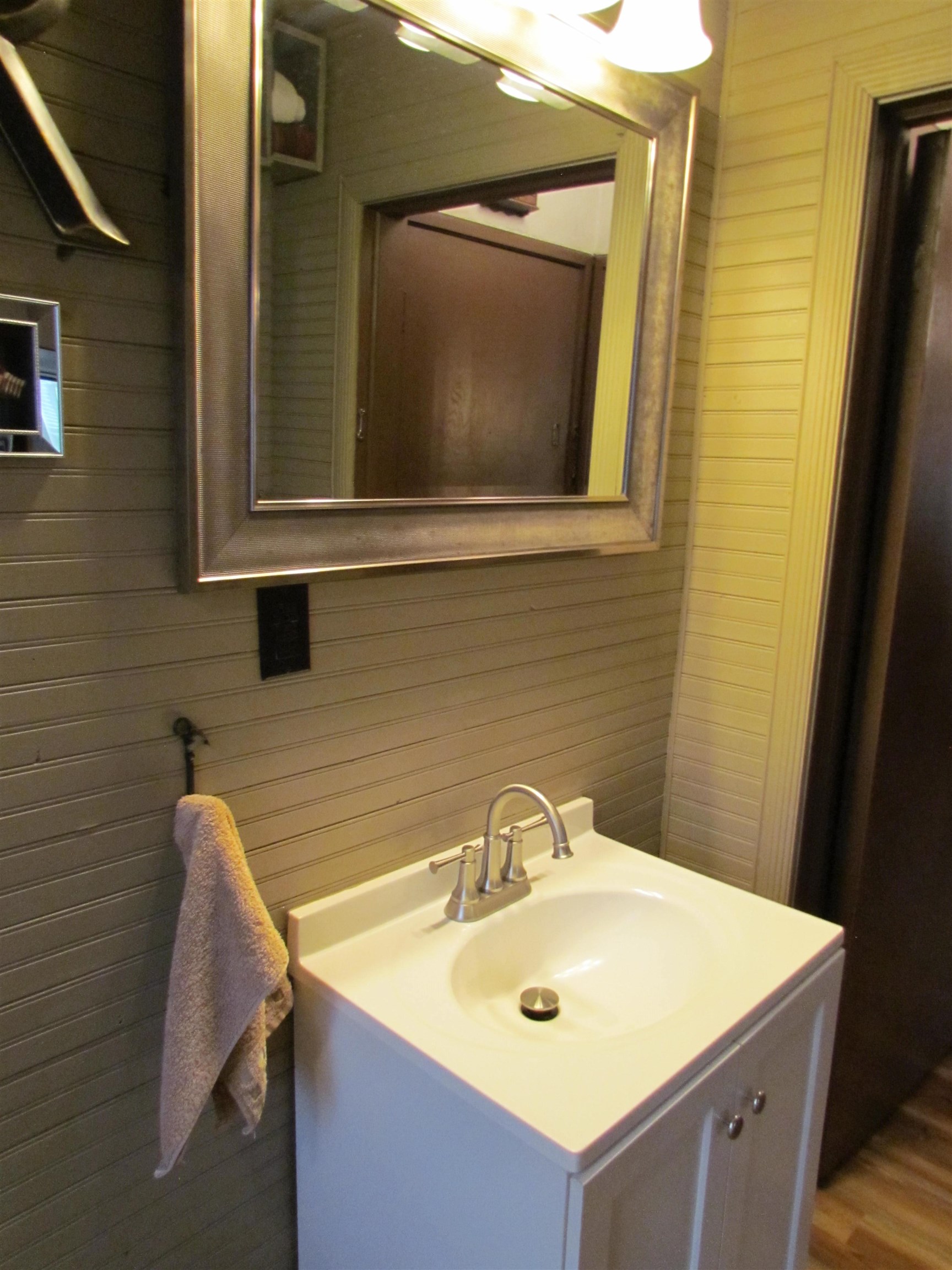 727 Elgin Street Cherry Valley, IL 61016 - Photo 16 of 35 a bathroom with a sink and a mirror
