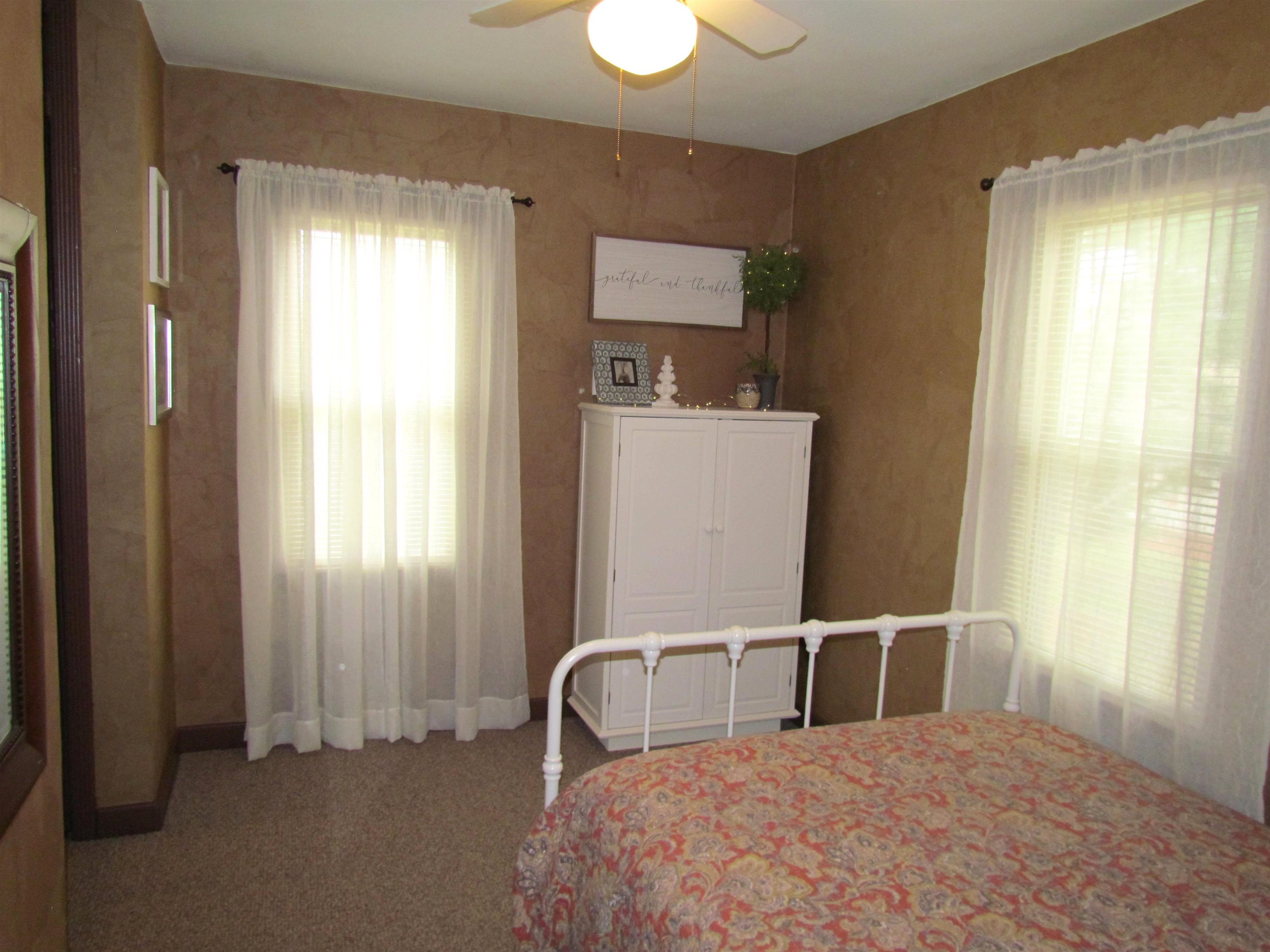 727 Elgin Street Cherry Valley, IL 61016 - Photo 19 of 35 a bedroom with a bed and a window