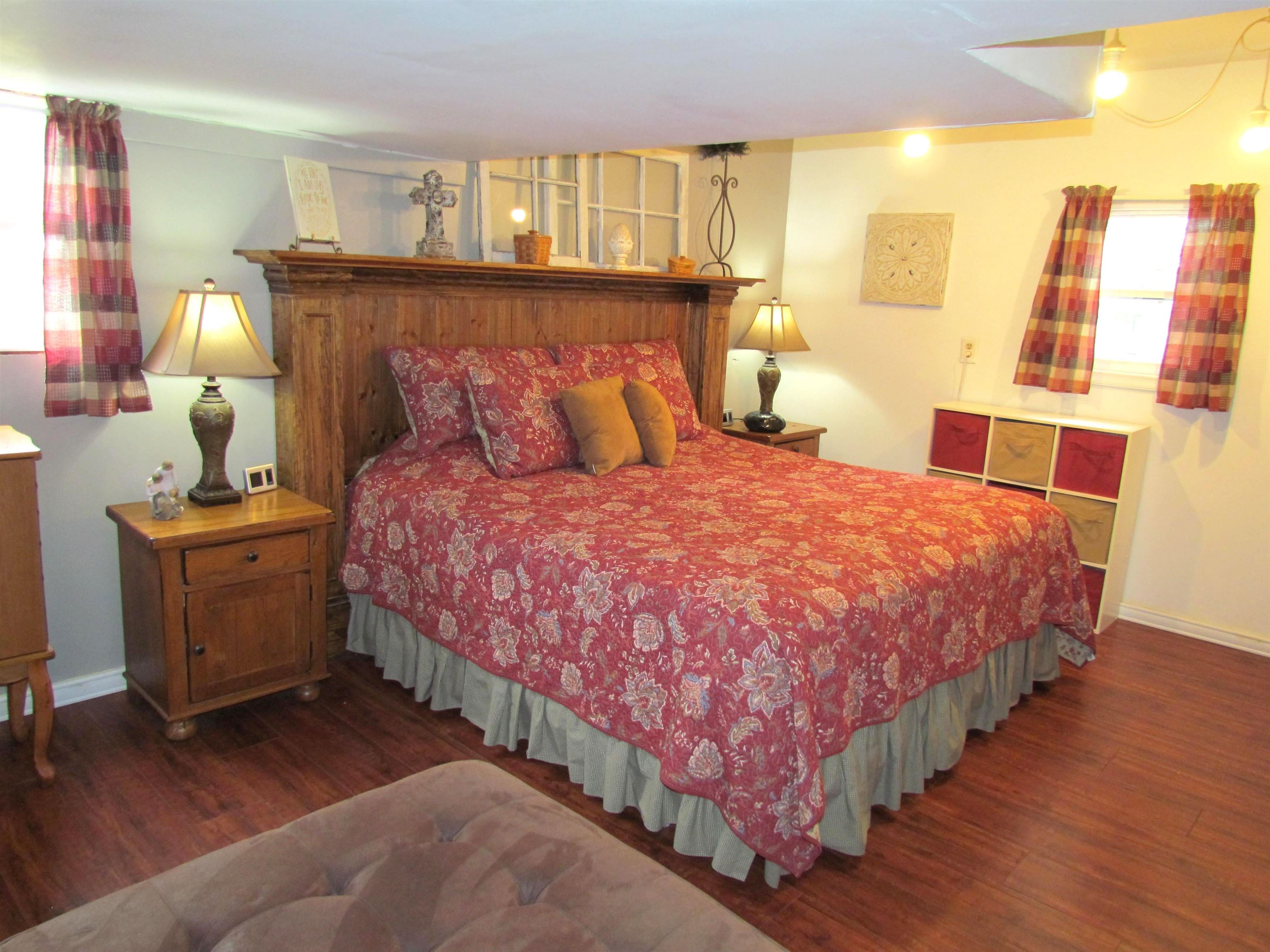 727 Elgin Street Cherry Valley, IL 61016 - Photo 20 of 35 a large bed sitting in a bedroom next to a window