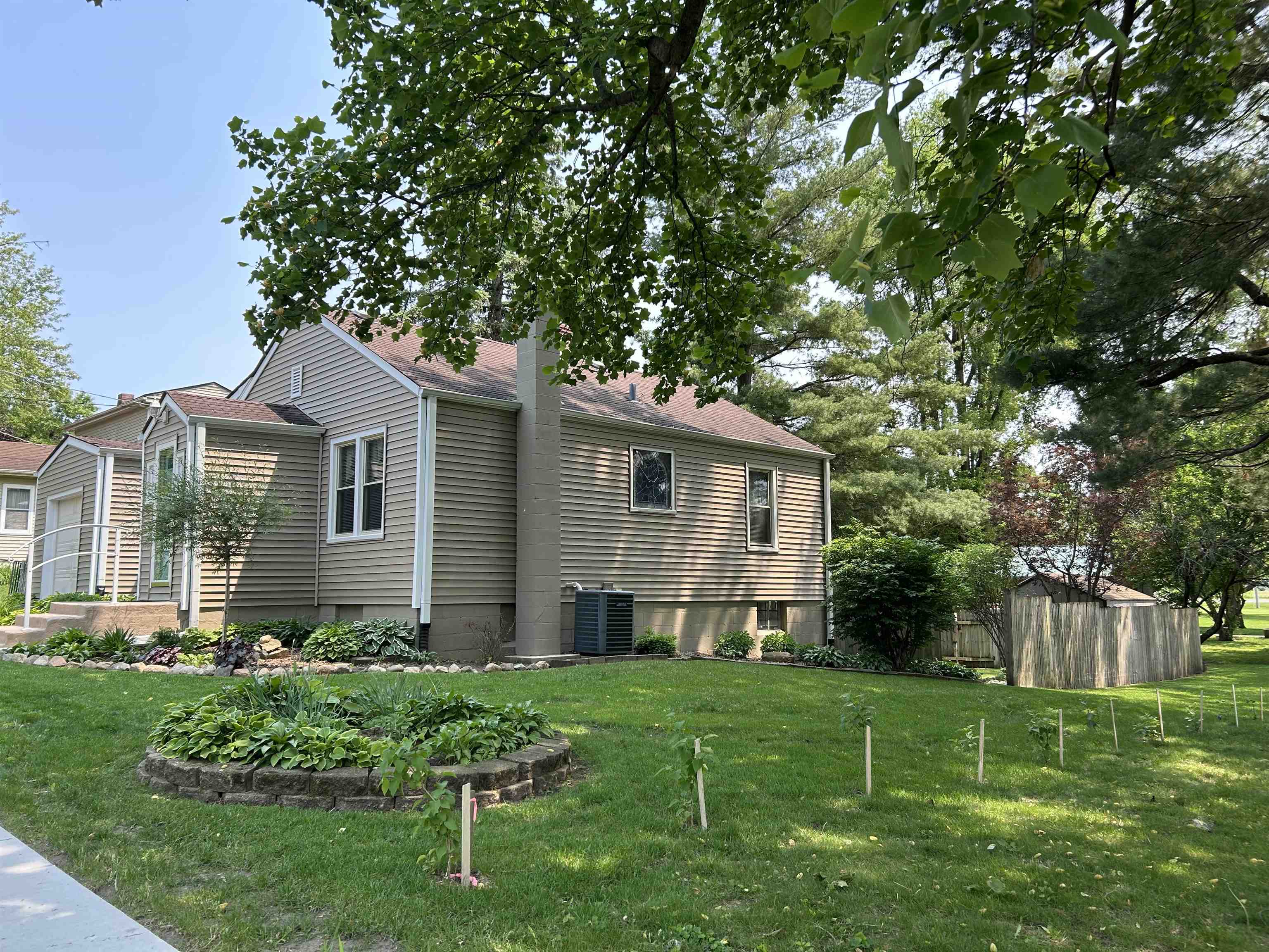 727 Elgin Street Cherry Valley, IL 61016 - Photo 2 of 35 a view of a house with backyard and a tree