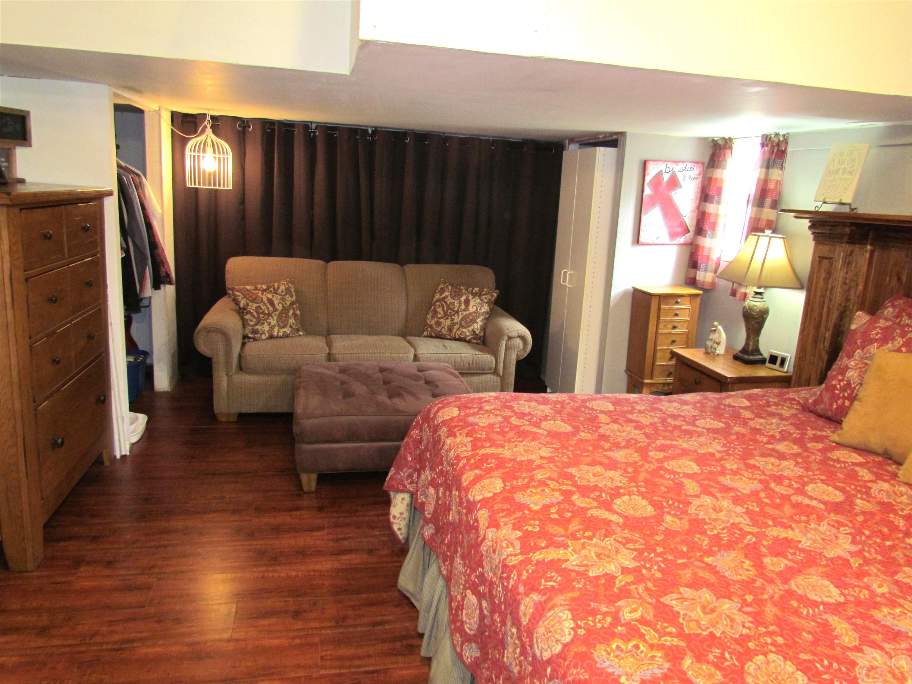 727 Elgin Street Cherry Valley, IL 61016 - Photo 22 of 35 a spacious bedroom with a bed and a mirror