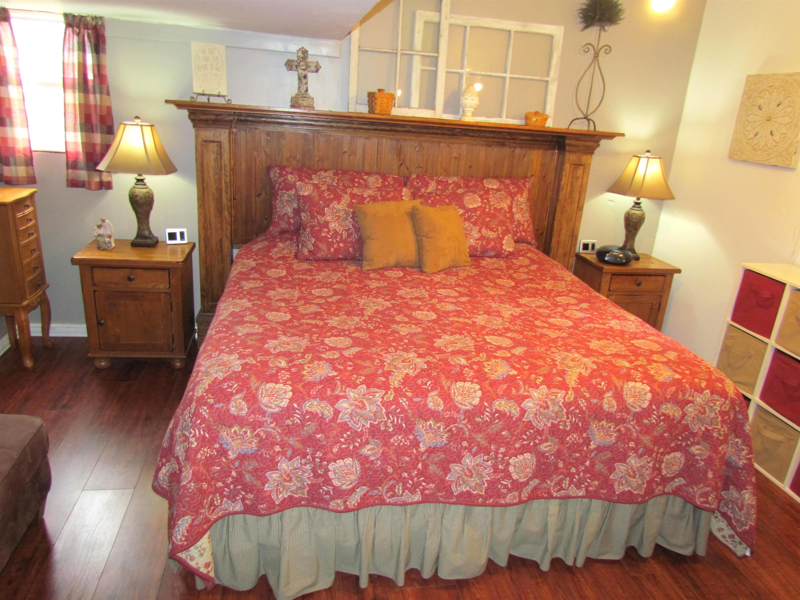 727 Elgin Street Cherry Valley, IL 61016 - Photo 25 of 35 a bed sitting in a bedroom next to a window