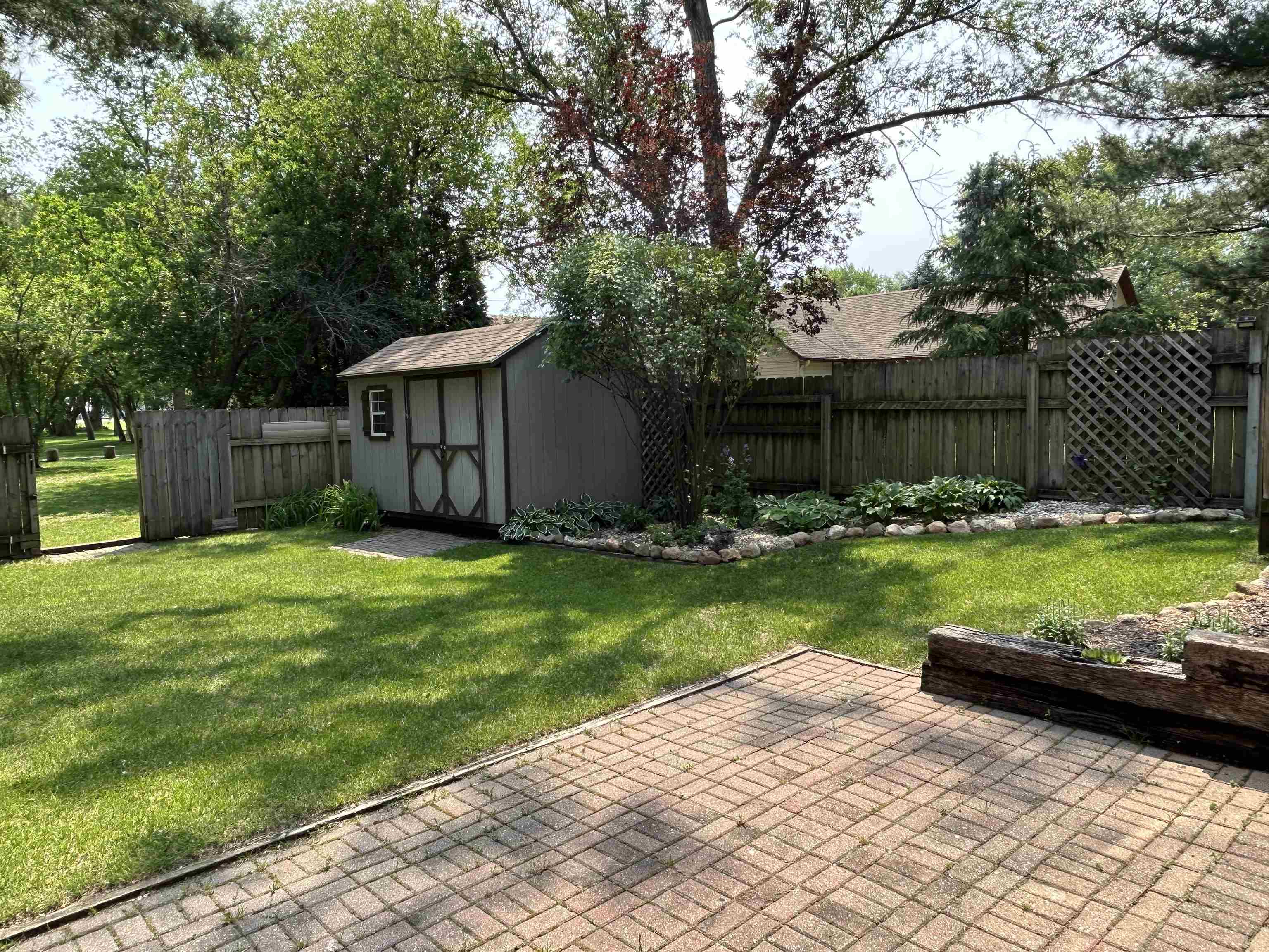 727 Elgin Street Cherry Valley, IL 61016 - Photo 32 of 35 a view of a house with a yard and a large tree