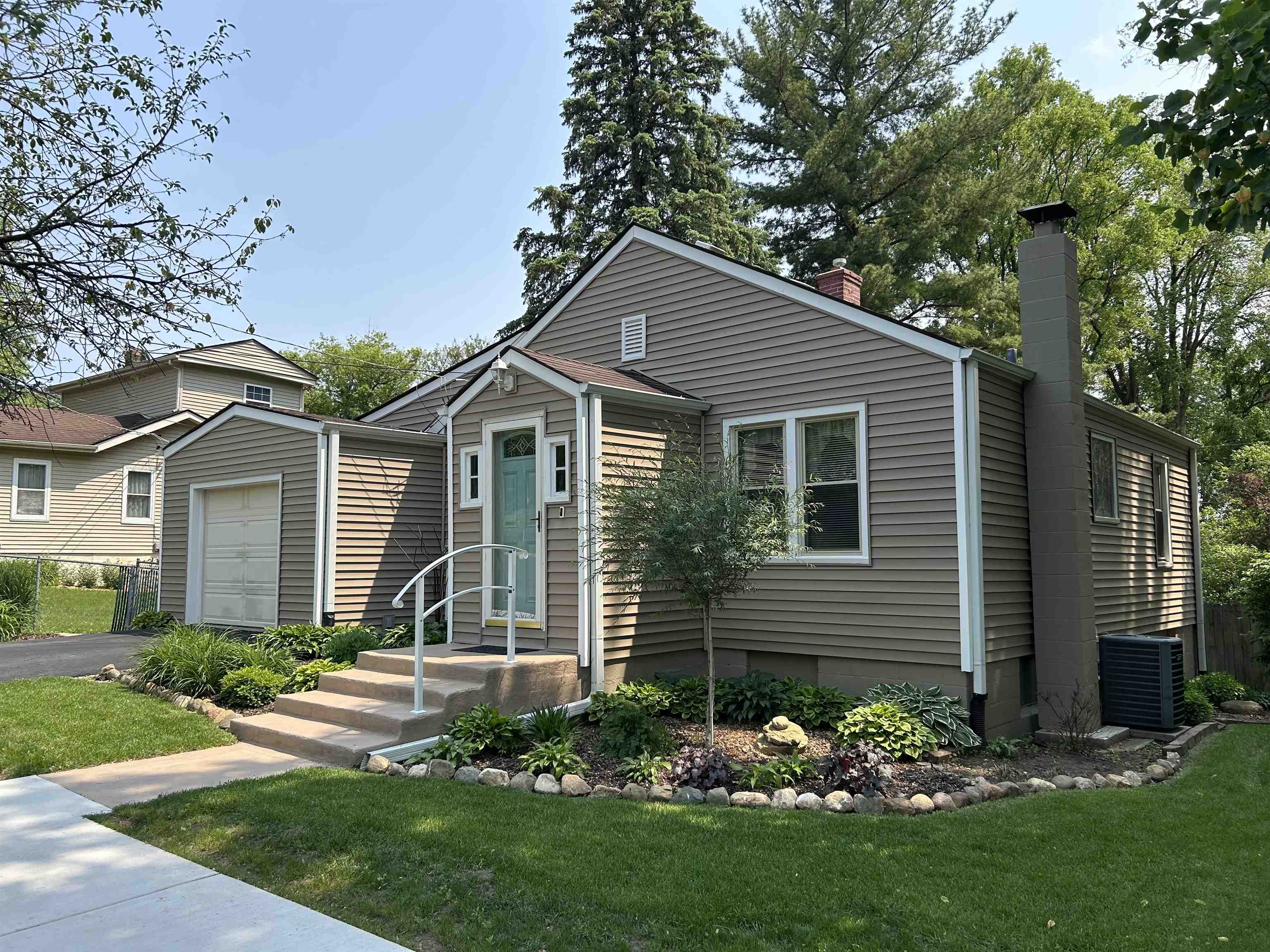 727 Elgin Street Cherry Valley, IL 61016 - Photo 34 of 35 a front view of a house with a garden