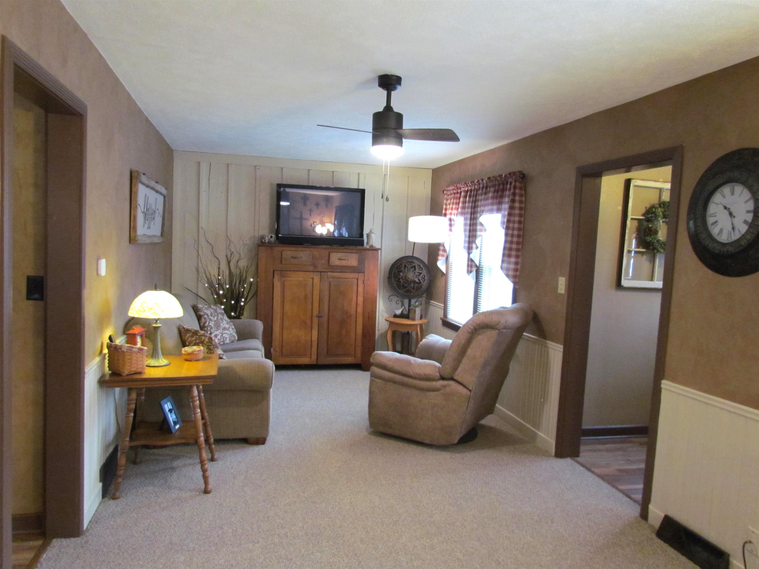 727 Elgin Street Cherry Valley, IL 61016 - Photo 6 of 35 a living room with furniture and a flat screen tv