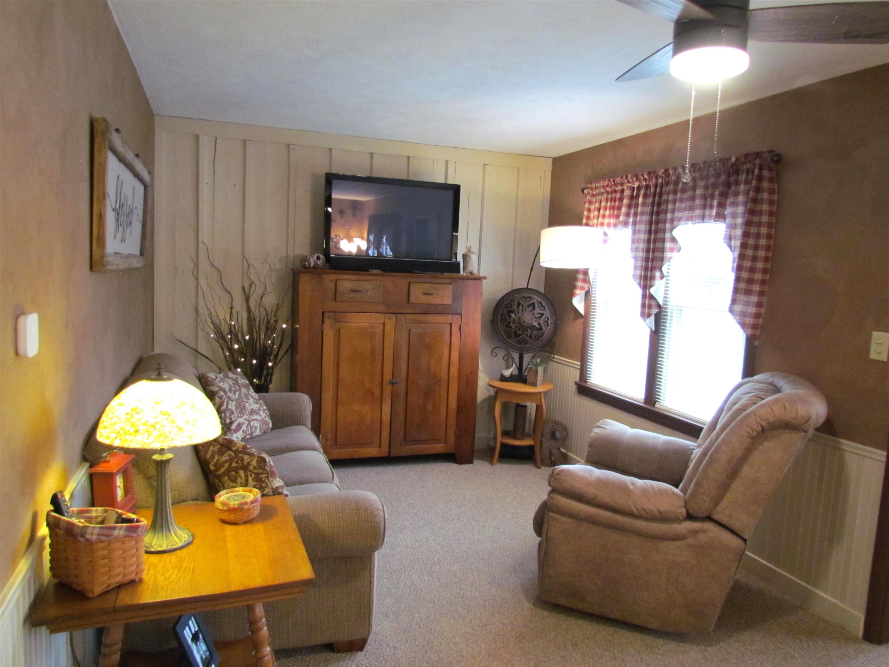 727 Elgin Street Cherry Valley, IL 61016 - Photo 7 of 35 a living room with furniture and a flat screen tv