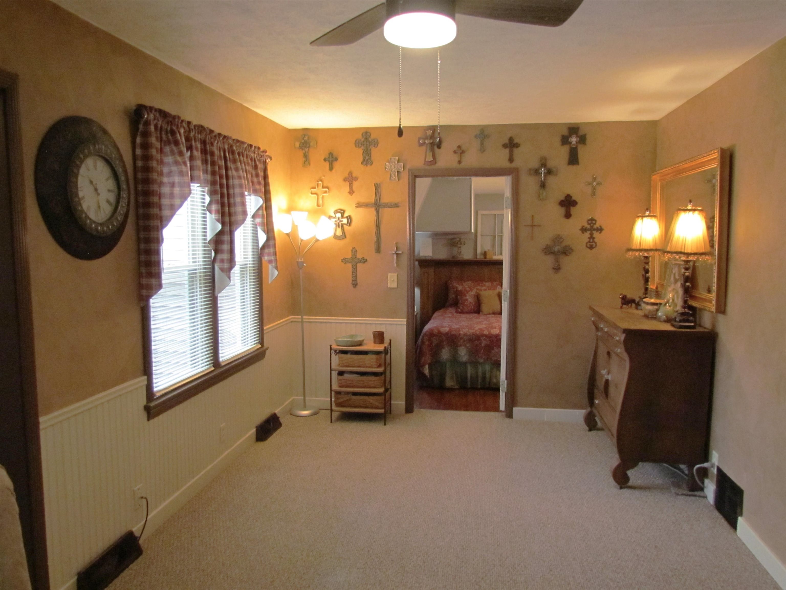 727 Elgin Street Cherry Valley, IL 61016 - Photo 8 of 35 a bedroom with a bed and a chandelier