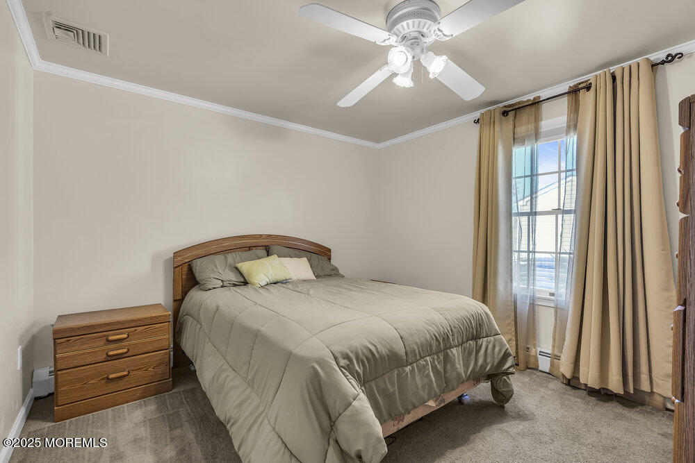 16 Davey Jones Way Waretown, NJ 08758 - Photo 12 of 21 a bedroom with a bed and a chandelier