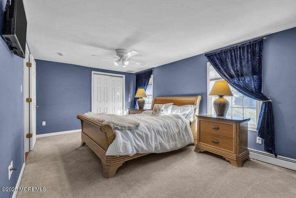 16 Davey Jones Way Waretown, NJ 08758 - Photo 14 of 21 a spacious bedroom with a bed and a lamp on dresser