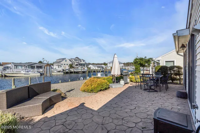 a view of a terrace with furniture and city view