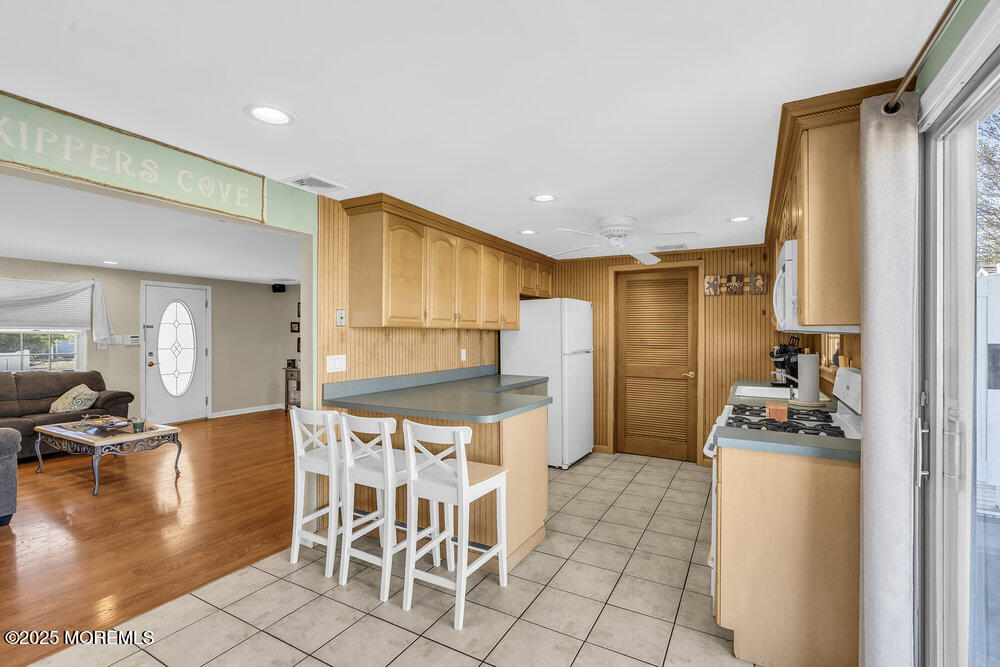 16 Davey Jones Way Waretown, NJ 08758 - Photo 5 of 21 a kitchen with granite countertop a refrigerator and a stove top oven