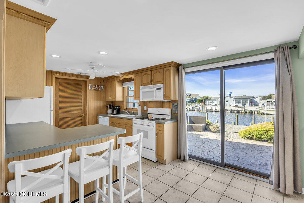 16 Davey Jones Way Waretown, NJ 08758 - Photo 7 of 21 a kitchen with a refrigerator and white cabinets