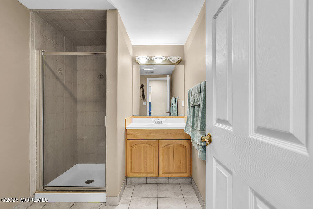 16 Davey Jones Way Waretown, NJ 08758 - Photo 9 of 21 a bathroom with a mirror and a shower