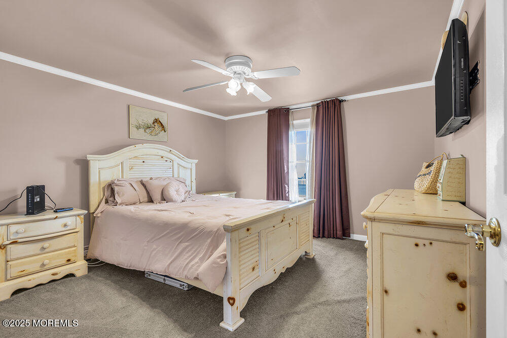 16 Davey Jones Way Waretown, NJ 08758 - Photo 10 of 21 a bedroom with a bed and a chandelier