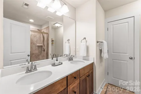 a bathroom with a double vanity sink mirror and double