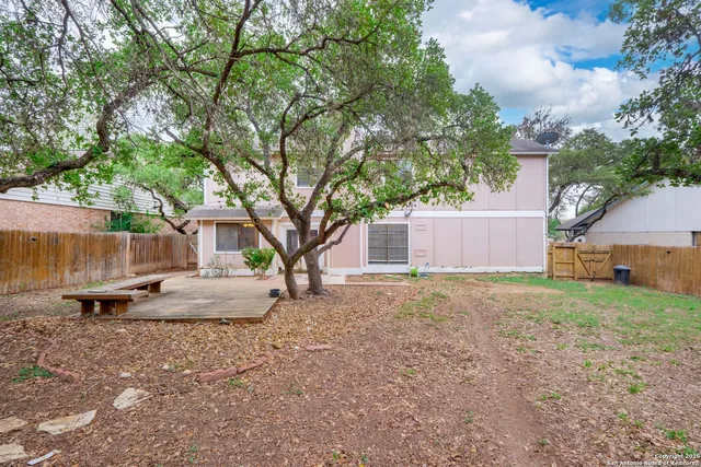 a view of a house with backyard and sitting area