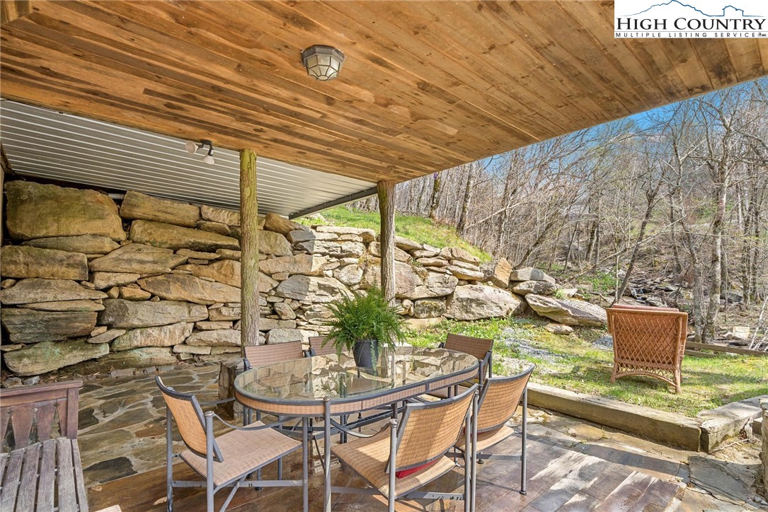 140 Spruce Hollow Road Beech Mountain, NC 28604 - Photo 34 of 50 a view of a patio with table and chairs and potted plants