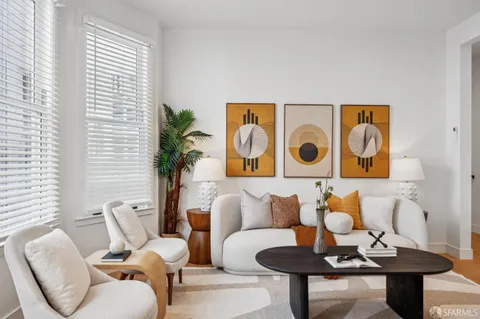 a living room with furniture and a potted plant