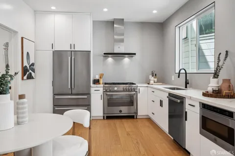 a kitchen with stainless steel appliances a refrigerator sink and stove