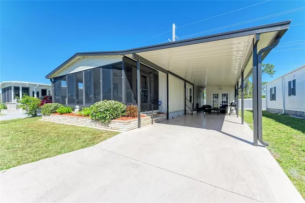 a view of a house with backyard and porch