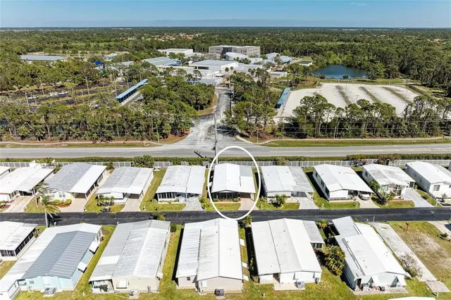 an aerial view of residential houses with outdoor space and swimming pool