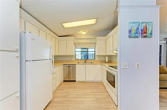 a kitchen with a refrigerator a sink and dishwasher