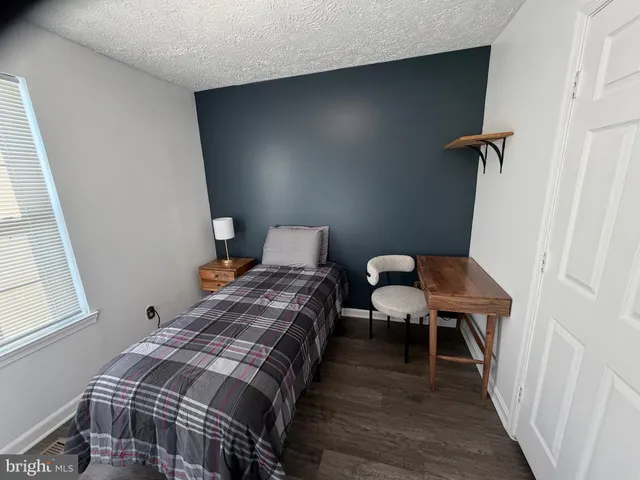 a bedroom with a bed and a table