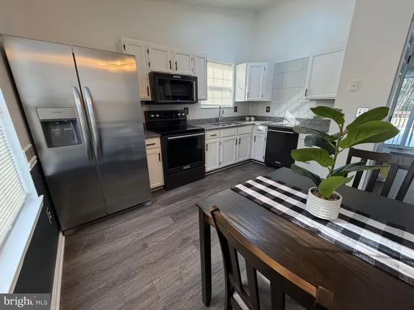 a kitchen with a sink stainless steel appliances and cabinets