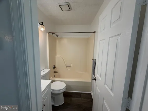 a bathroom with a toilet a sink and shower