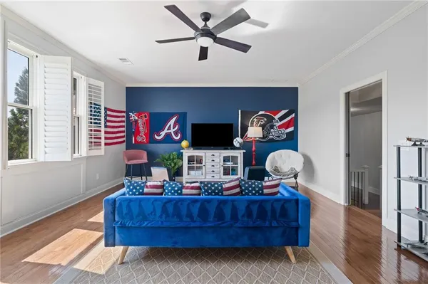 a bed sitting in a spacious bedroom next to a window