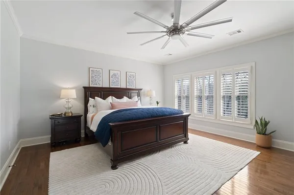 a living room with a bed furniture and a flat screen tv