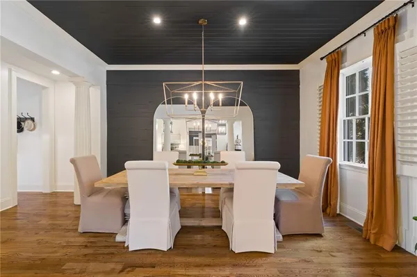 a dining room with furniture and wooden floor
