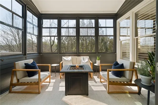 a kitchen with stainless steel appliances kitchen island granite countertop a table chairs and white cabinets