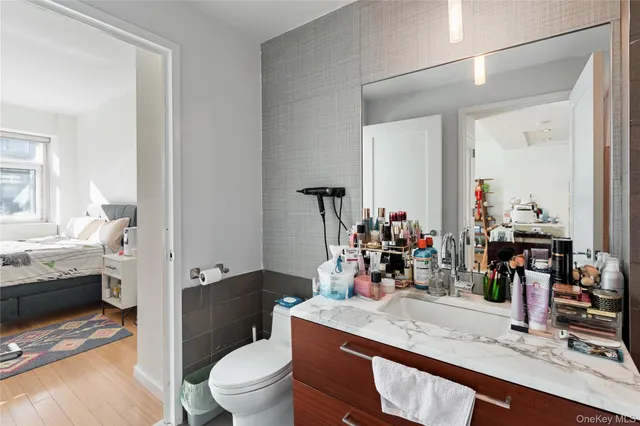 a very nice looking room with a large mirror and a sink