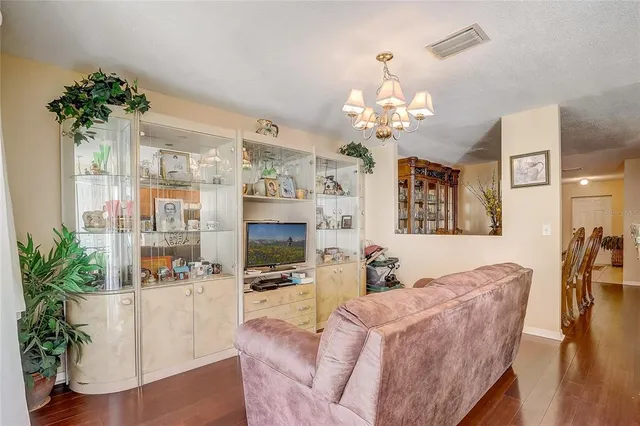 a view of a house with brick walls and a yard with plants