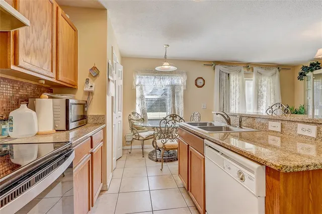 an aerial view of a house with a yard and lake view