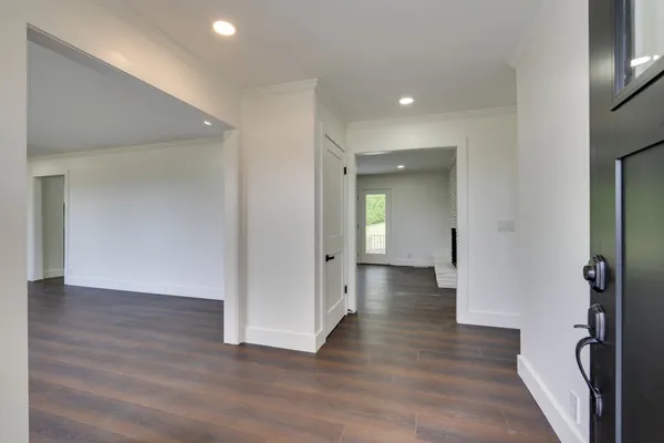 a view of a hallway with wooden floor