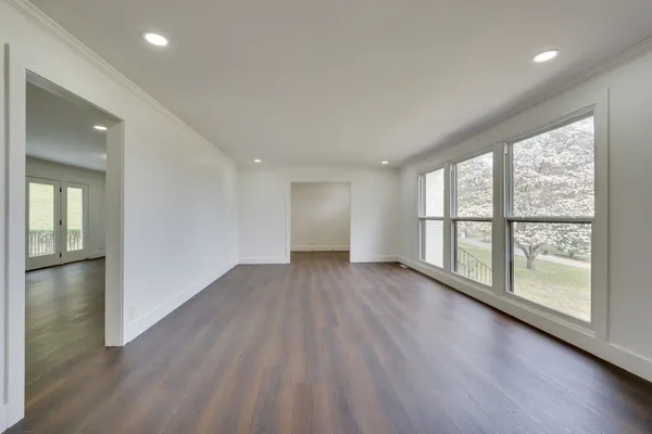 wooden floor in an empty room with a window